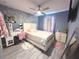 Comfortable bedroom with modern decor, ample closet space, and a desk area for studying or work at 10221 Carloway Hills Dr, Wimauma, FL 33598