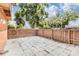 Large fenced backyard with trees and a paved area, offering privacy and outdoor space at 10520 Winrock Pl, Tampa, FL 33624