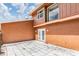 Spacious backyard with white tile patio and brown exterior paint at 10520 Winrock Pl, Tampa, FL 33624