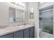 Bathroom with a vanity, sink, dual mirrors, and a shower, providing functionality and style at 10520 Winrock Pl, Tampa, FL 33624