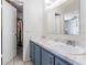 Bathroom featuring a vanity, sink, and a closet with clothing, providing ample storage at 10520 Winrock Pl, Tampa, FL 33624