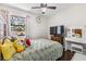 Bright bedroom with a ceiling fan, window view, and stylish decor at 10520 Winrock Pl, Tampa, FL 33624