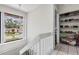Hallway showcasing a window, closet shelving, and a staircase leading to another level at 10520 Winrock Pl, Tampa, FL 33624