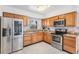Spacious kitchen with stainless steel appliances, wooden cabinets, and granite countertops at 10520 Winrock Pl, Tampa, FL 33624