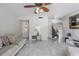Bright living room featuring stairs to the second floor, stylish floors and modern lighting at 10520 Winrock Pl, Tampa, FL 33624