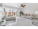 Sun-filled living room featuring tile floors and sliding glass doors to backyard at 10520 Winrock Pl, Tampa, FL 33624