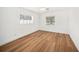 Bedroom featuring hardwood flooring, ceiling fan and two windows offering natural light at 1100 Snell Isle Ne Blvd, St Petersburg, FL 33704