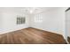 Bright bedroom with wood flooring features a ceiling fan and a mirrored closet providing ample storage at 1100 Snell Isle Ne Blvd, St Petersburg, FL 33704