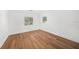 Spacious bedroom with hardwood flooring and two windows offering natural light at 1100 Snell Isle Ne Blvd, St Petersburg, FL 33704