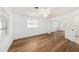 Bright bedroom with a ceiling fan, wood flooring, and a mirrored closet showcasing a modern design at 1100 Snell Isle Ne Blvd, St Petersburg, FL 33704