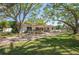Beautiful single-story home with lush landscaping, mature trees, and a brick paved driveway at 1100 Snell Isle Ne Blvd, St Petersburg, FL 33704