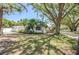 Charming home featuring mature trees, well-manicured lawn, and an attached garage at 1100 Snell Isle Ne Blvd, St Petersburg, FL 33704
