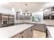 Modern kitchen with stainless steel appliances, white countertops, and gray cabinetry with recessed lighting at 1100 Snell Isle Ne Blvd, St Petersburg, FL 33704