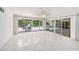 Bright living area with tile floors offers access to the pool and patio through sliding glass doors at 1100 Snell Isle Ne Blvd, St Petersburg, FL 33704