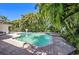 Backyard with a sparkling swimming pool surrounded by lush landscaping at 1100 Snell Isle Ne Blvd, St Petersburg, FL 33704