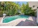 Backyard with a sparkling swimming pool surrounded by lush tropical landscaping at 1100 Snell Isle Ne Blvd, St Petersburg, FL 33704