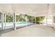 Screened in patio featuring ceiling fans and views of a swimming pool at 1100 Snell Isle Ne Blvd, St Petersburg, FL 33704