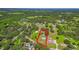 Expansive aerial view of a lush, green property with a home, pool, outbuildings, and bordering treeline at 1105 Branch Acres Dr, Plant City, FL 33565