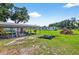 View of a large open carport and utility storage in the large backyard at 1105 Branch Acres Dr, Plant City, FL 33565