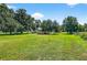 Picture of the property with sheds and a trailer among beautiful trees in a well maintained yard at 1105 Branch Acres Dr, Plant City, FL 33565
