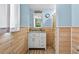 Bathroom featuring shiplap walls, white vanity, and shower at 1105 Branch Acres Dr, Plant City, FL 33565