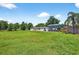 Exterior home view, showing the lush lawn and mature landscaping on a sunny day at 1105 Branch Acres Dr, Plant City, FL 33565