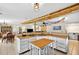 Open kitchen with butcher block countertops, tile floor, and a central island at 1105 Branch Acres Dr, Plant City, FL 33565