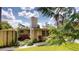 View of the side of the home and the backyard, featuring a lawn and a partially covered area at 12113 Victory Dr, Hudson, FL 34667