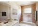 Staged bathroom features tiled walls, a tub, vanity with sink, and decorative elements at 12113 Victory Dr, Hudson, FL 34667