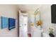 Stylishly staged bathroom featuring a white vanity, decorative mirror and staged with towels and decorative accents at 12113 Victory Dr, Hudson, FL 34667