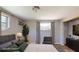 Staged bedroom features neutral walls, carpeted floors, window AC, and a large bed at 12113 Victory Dr, Hudson, FL 34667