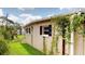 Side view of the home exterior with green lawn, showcasing mature landscaping and a tranquil setting at 12113 Victory Dr, Hudson, FL 34667
