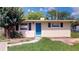 Inviting single-story home with a well-maintained front lawn and blue door at 12113 Victory Dr, Hudson, FL 34667