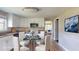 Chic kitchen with white cabinetry and a cozy dining area at 12113 Victory Dr, Hudson, FL 34667