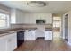 Modern kitchen with new white cabinets, stainless steel microwave, and granite countertops at 12113 Victory Dr, Hudson, FL 34667