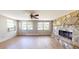 Spacious living room boasts hardwood floors, large windows, and a stone fireplace at 12113 Victory Dr, Hudson, FL 34667