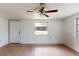 Open-concept living area featuring new floors and a ceiling fan at 12113 Victory Dr, Hudson, FL 34667