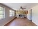 Spacious living room boasts hardwood floors, large windows, and a stone fireplace at 12113 Victory Dr, Hudson, FL 34667