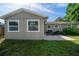 Home exterior with a patio set on a concrete slab in the backyard at 124 E Virginia Ln, Clearwater, FL 33759