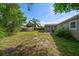 Home exterior with a view of the patio and a fenced backyard at 124 E Virginia Ln, Clearwater, FL 33759