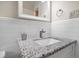 Updated bathroom with a speckled granite countertop, undermount sink, and modern fixtures at 124 E Virginia Ln, Clearwater, FL 33759