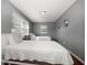Bright bedroom featuring hardwood floors, two beds, and ample natural light at 124 E Virginia Ln, Clearwater, FL 33759