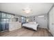 Bright bedroom with hardwood floors, a ceiling fan, and gray walls and matching decor at 124 E Virginia Ln, Clearwater, FL 33759