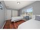 Inviting bedroom with two beds, hardwood floors, and plenty of natural light at 124 E Virginia Ln, Clearwater, FL 33759