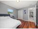 Cozy bedroom with wood floors, natural light, and stylish gray accents and decor at 124 E Virginia Ln, Clearwater, FL 33759