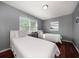 Cozy bedroom featuring hardwood floors, two beds, and ample natural light at 124 E Virginia Ln, Clearwater, FL 33759