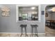 Bright kitchen view from the breakfast bar featuring white cabinets and stainless steel appliances at 124 E Virginia Ln, Clearwater, FL 33759