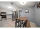 Well-lit kitchen with stainless steel appliances, white cabinets, and an adjacent breakfast nook at 124 E Virginia Ln, Clearwater, FL 33759