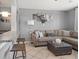 Cozy living room featuring a large sectional sofa, modern decor, and an open layout at 124 E Virginia Ln, Clearwater, FL 33759