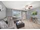 Inviting living room featuring tile floors, a large sectional sofa, and plenty of natural light at 124 E Virginia Ln, Clearwater, FL 33759